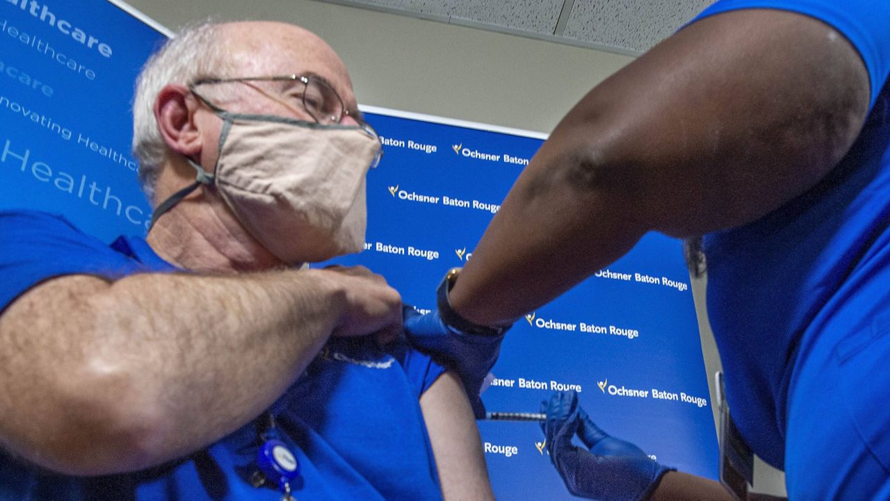 Dr. Jay Brooks receives a COVID-19 vaccine in Baton Rouge, La., on Dec. 15. (Bill Feig/The Advocate via AP, Pool)