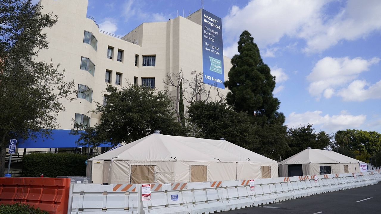 Medical tents are set up outside the emergency room at UCI Medical Center Thursday, Dec 17, 2020, in Irvine, Calif. California health authorities reported Thursday a record 379 coronavirus deaths and more than 52,000 new confirmed cases. (AP Photo/Ashley Landis)