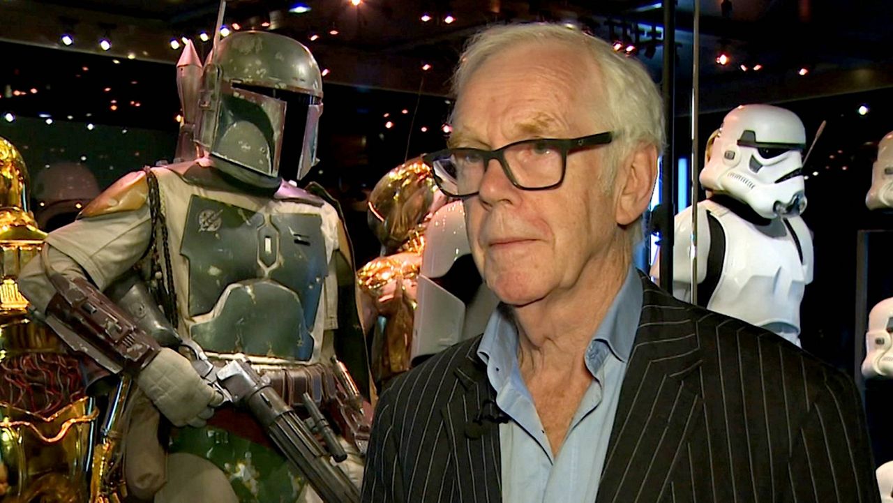 Jeremy Bulloch speaks in front of the costume he wore while playing Boba Fett in "Star Wars: Episode V – The Empire Strikes Back" and "Star Wars: Episode VI – Return of the Jedi" at the Star Wars Identities exhibition in London on July 26, 2017. (AP Photo)