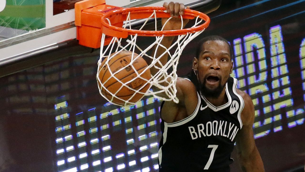 Brooklyn Nets forward Kevin Durant (7) dunks during the second half of an NBA preseason basketball game against the Boston Celtics, Friday, Dec. 18, 2020, in Boston. (AP Photo/Mary Schwalm)