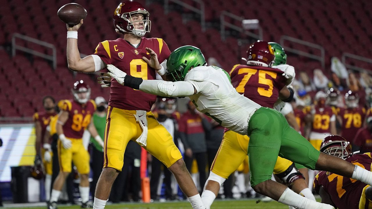 Southern California quarterback Kedon Slovis (9) is tackled by Oregon defensive end Kayvon Thibodeaux (5) during the second quarter of an NCAA college football game for the Pac-12 Conference championship Friday, Dec 18, 2020, in Los Angeles. (AP Photo/Ashley Landis)