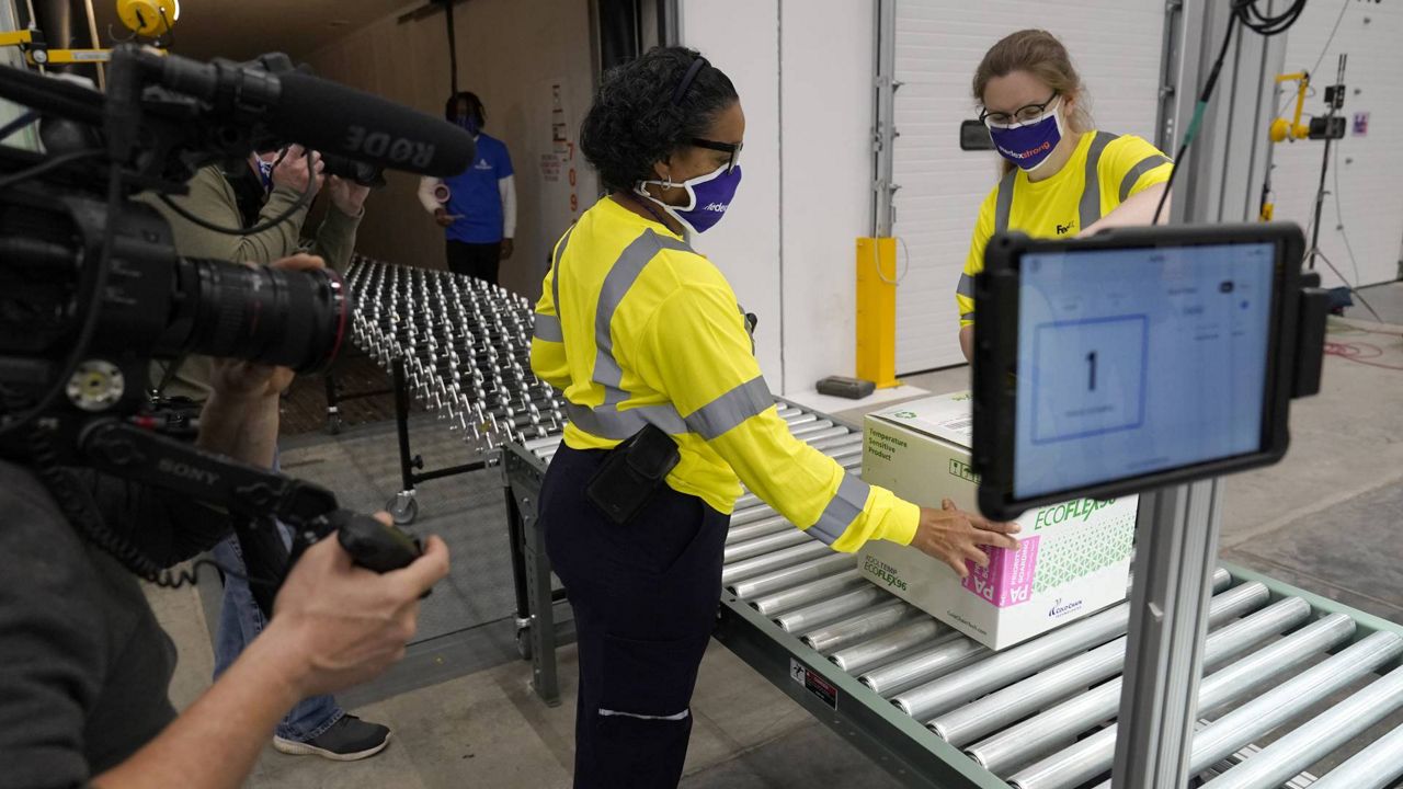 Boxes containing the Moderna COVID-19 vaccine are prepared to be shipped at the McKesson distribution center in Olive Branch, Miss., Sunday, Dec. 20, 2020. (AP Photo/Paul Sancya, Pool