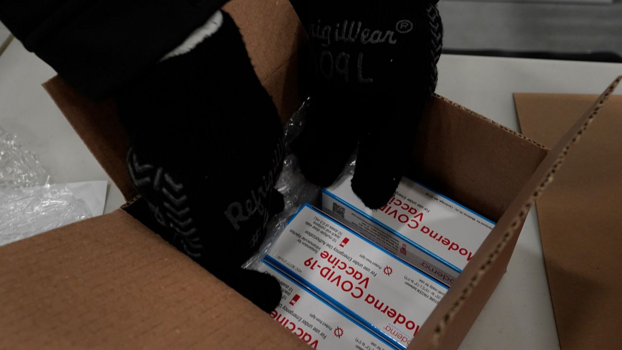 Boxes containing the Moderna COVID-19 vaccine are packed for shipping at the McKesson distribution center in Olive Branch, Miss., Sunday, Dec. 20, 2020. (AP Photo/Paul Sancya, Pool)