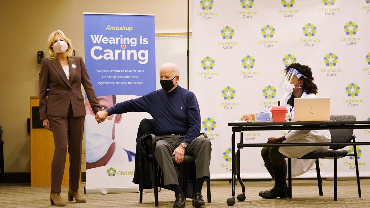 President-elect Joe Biden received his first dose of the coronavirus vaccine at ChristianaCare Christiana Hospital in Newark, Del., Monday, Dec. 21, 2020, from nurse practitioner Tabe Mase, as Jill Biden looks on. (AP Photo/Carolyn Kaster)