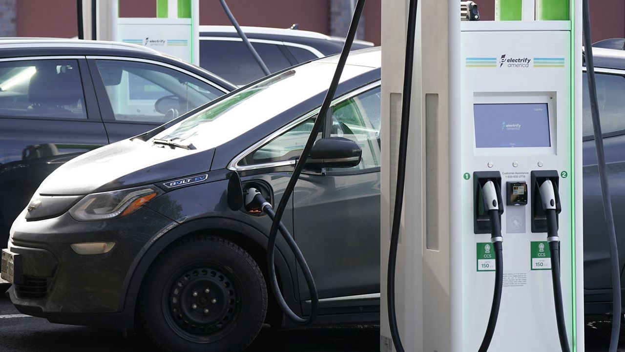 A Chevrolet Bolt charges at an Electrify America site in Lakewood, Colo. (AP Photo/David Zalubowski, File)