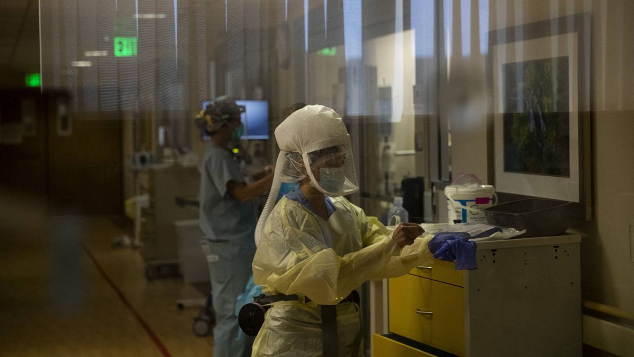 Registered nurse Shamaine Santos works in a COVID-19 unit at St. Jude Medical Center in Fullerton, Calif., Tuesday, July 7, 2020. (AP Photo/Jae C. Hong)