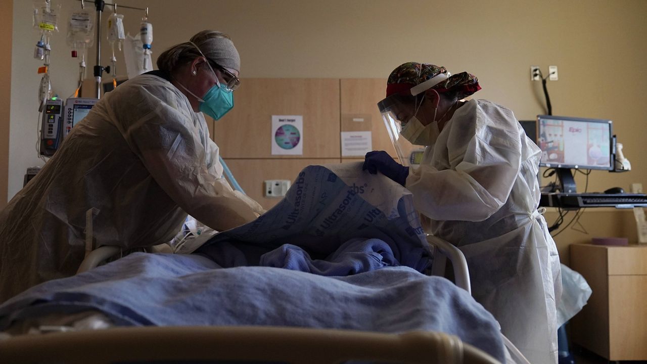 Nurses at Providence Holy Cross Medical Center in Los Angeles treat a COVID-19 patient on Dec. 22. (AP Photo/Jae C. Hong)