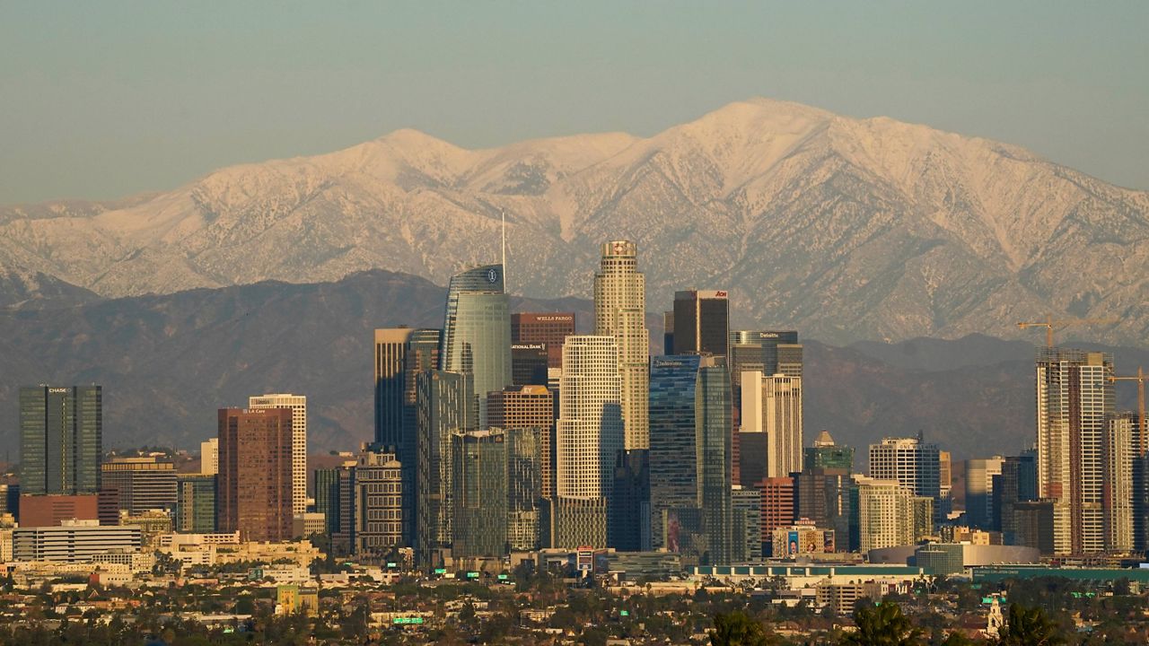 Snow covers mountains behind the downtown Los Angeles skyline Tuesday, Dec. 29, 2020, in Los Angeles. (AP Photo/Ashley Landis)
