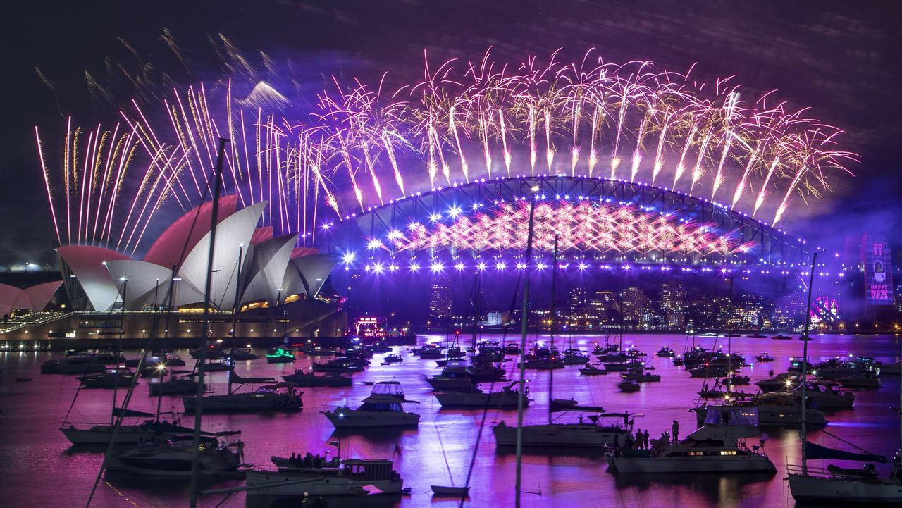 Fireworks explode over the Sydney Opera House and Harbour Bridge as New Year celebrations begin in Sydney, Australia, Thursday, Dec. 31, 2020. (AP Photo/Mark Baker)