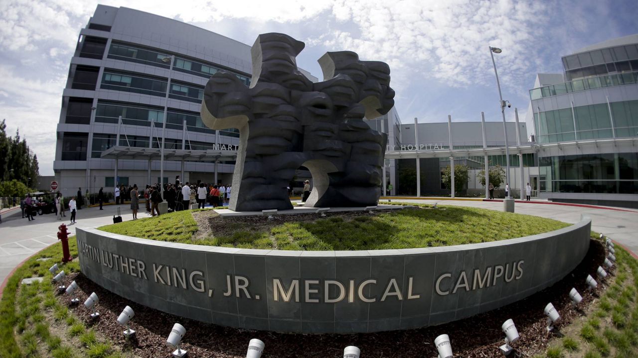 Members of the hospital staff gather outside as part of the inauguration for the new Martin Luther King Jr. Community Hospital on Aug. 6, 2015 in the Watts area of L.A. (AP/Chris Carlson)