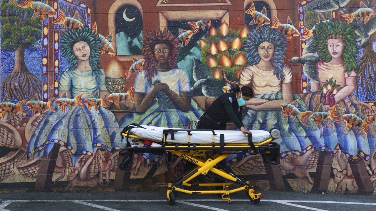 Ana Galicia readies a stretcher after transporting a patient, outside Exodus Mental Health Urgent Care Clinic in Los Angeles on Jan. 5, 2021. (AP Photo/Damian Dovarganes)
