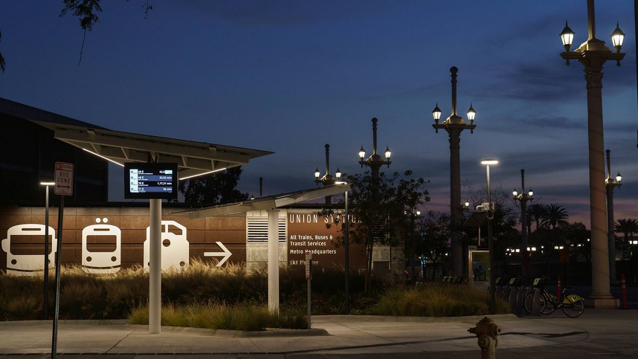 An empty Metro bus stops is seen next to Union Station in Los Angeles late afternoon Tuesday, Jan. 5, 2021. (AP Photo/Damian Dovarganes)