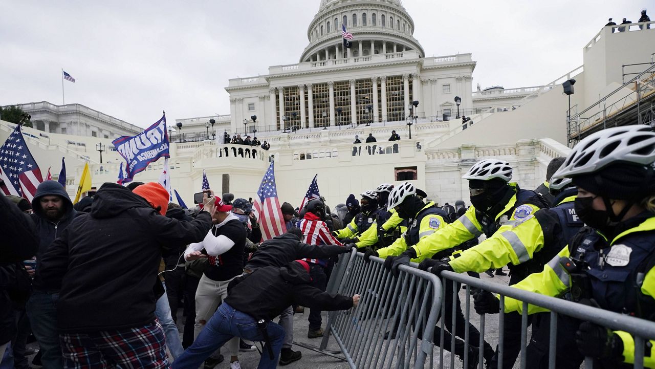 Trump supporters try to break through a police barrier Wednesday at the Capitol in Washington. (AP Photo/Julio Cortez)
