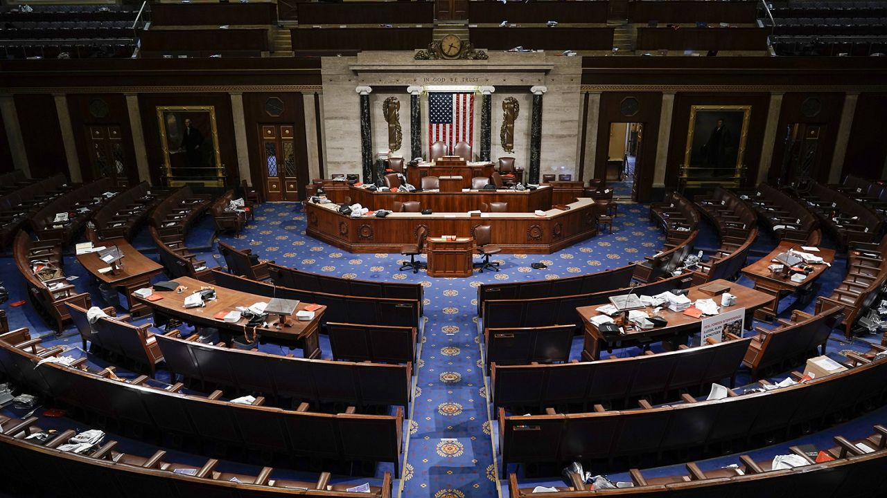 The House Chamber is empty after a hasty evacuation as protesters tried to break into the chamber at the U.S. Capitol on Wednesday, Jan. 6, 2021, in Washington. (AP Photo/J. Scott Applewhite)