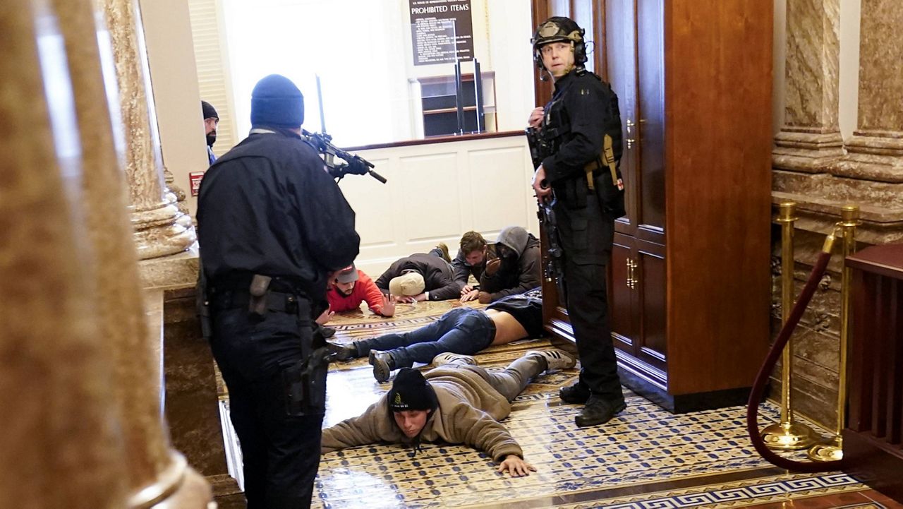 U.S. Capitol Police hold rioters at gunpoint near the House chamber inside the U.S. Capitol on Jan. 6. (AP Photo/Andrew Harnik)