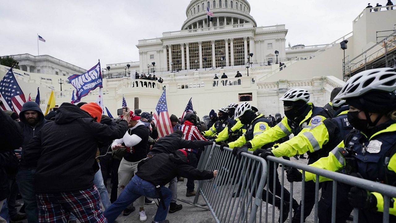 Trump supporters try to break through a police barrier on Jan. 6, 2021, at the Capitol in Washington. (AP Photo/Julio Cortez)