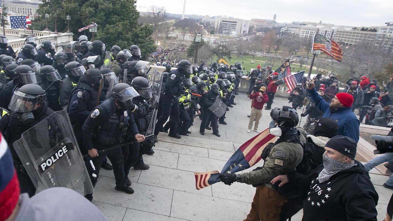 U.S. Capitol Police push back demonstrators who were trying to enter the U.S. Capitol on Wednesday, Jan. 6, 2021, in Washington. (AP Photo/Jose Luis Magana)