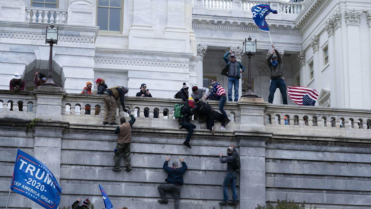 Supporters of President Donald Trump climb the west wall of the the U.S. Capitol on Wednesday. (AP Photo/Jose Luis Magana)