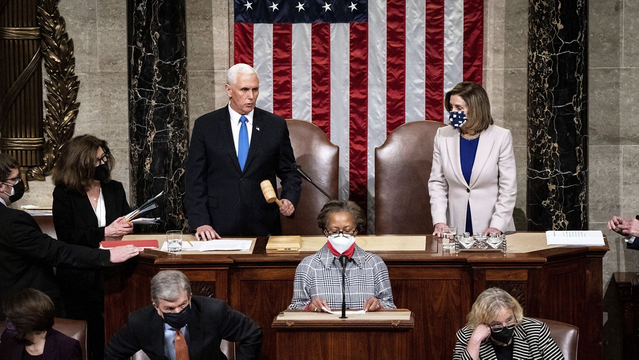 Speaker of the House Nancy Pelosi, D-Calif., and Vice President Mike Pence officiate as a joint session of the House and Senate reconvenes to confirm the Electoral College votes at the Capitol, Wednesday, Jan 6, 2021. (Erin Schaff/The New York Times via AP, Pool)