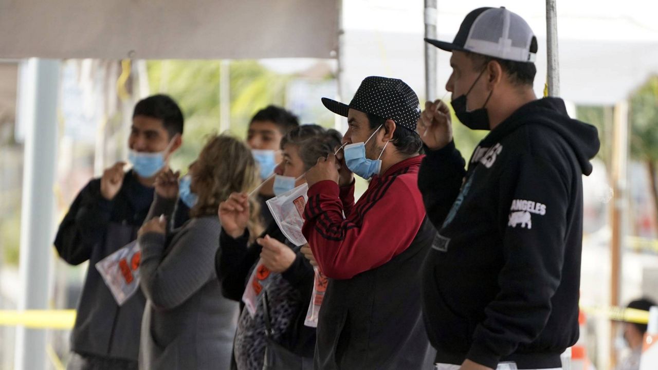 People take a COVID-19 test on the Martin Luther King Jr. Medical Campus, Thursday, Jan. 7, 2021, in Los Angeles. (AP Photo/Marcio Jose Sanchez)