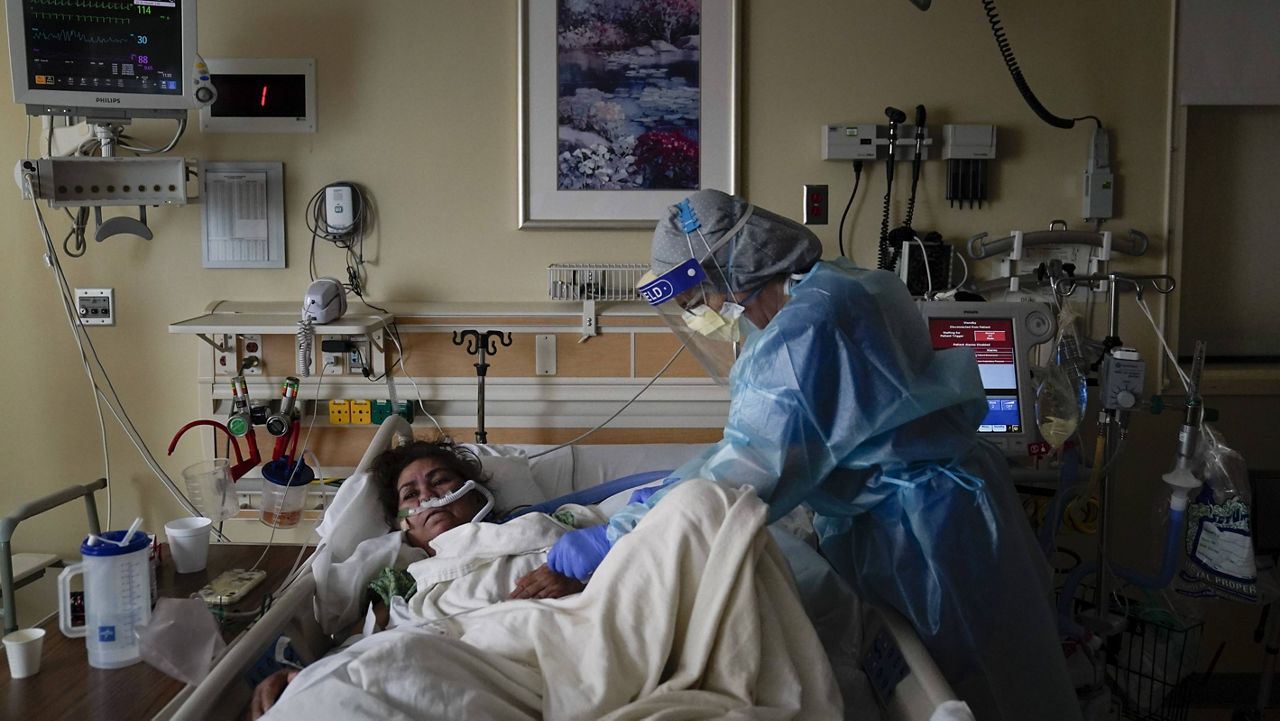 Registered nurse Merri Lynn Anderson tends to her patient in a COVID-19 unit at St. Joseph Hospital in Orange, Calif., on Thursday. (AP Photo/Jae C. Hong)