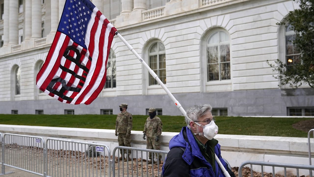 A protester walks past the Russell Senate Office Building on Capitol Hill in Washington on Friday. (AP Photo/Patrick Semansky)