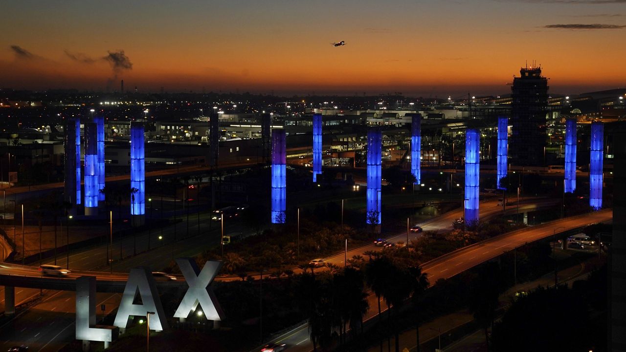 Pylons at Los Angeles International Airport are illuminated in "Dodger Blue" in tribute to the late longtime Los Angeles Dodgers manager Tommy Lasorda, Friday, Jan. 8, 2021, in Los Angeles. Lasorda died of a heart attack Thursday night at his home in Fullerton, Calif. He was 93. (AP Photo/Chris Pizzello)