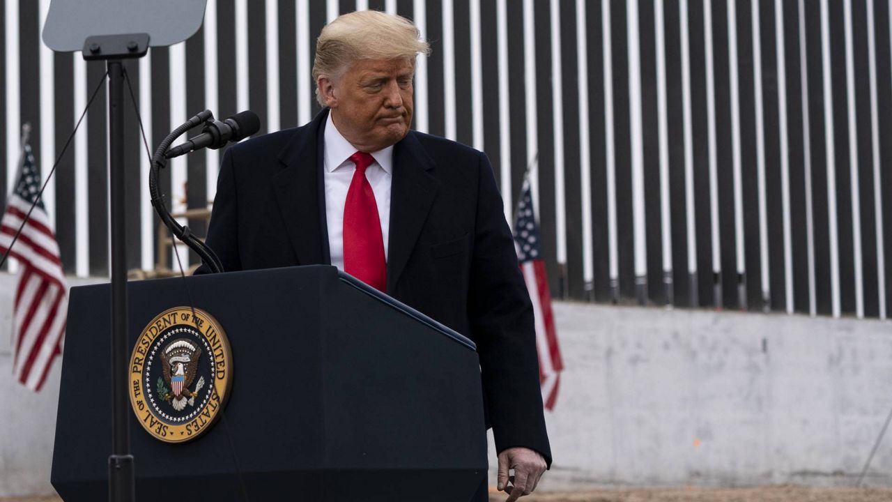 President Donald Trump steps away from the podium after speaking near a section of the U.S.-Mexico border wall, Tuesday, Jan. 12, 2021, in Alamo, Texas. (AP Photo/Alex Brandon)