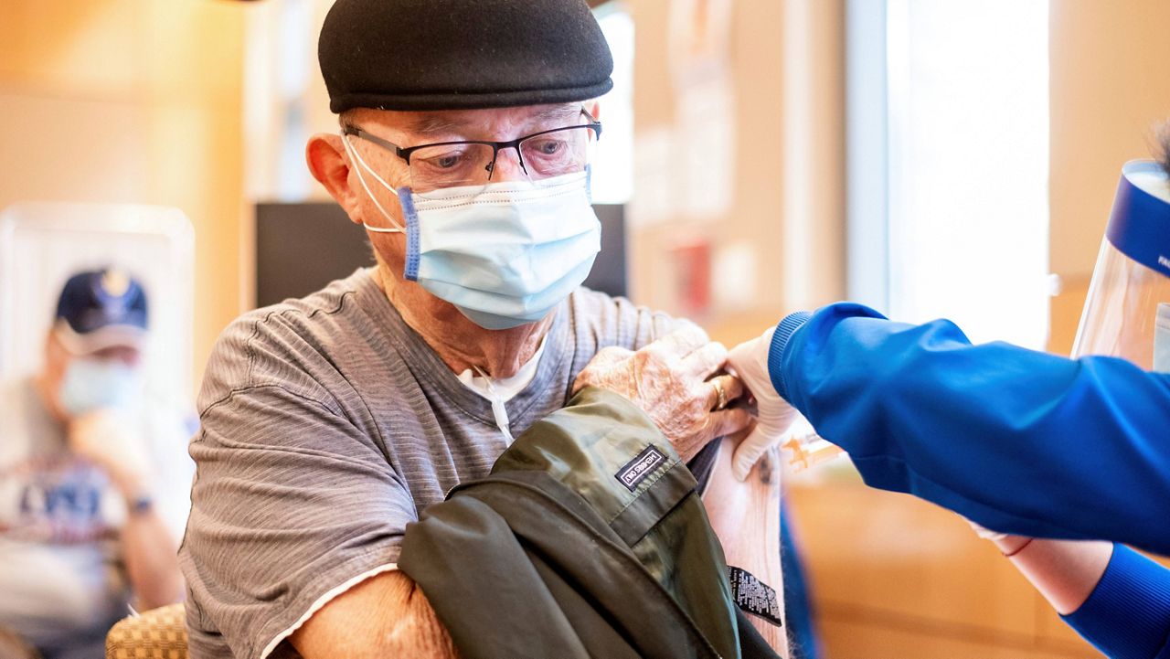 Jim Clark, 86, receives a first dose of Pfizer-BioNTech COVID-19 vaccine from UC Davis Health on Jan. 12, 2021, in Sacramento, Calif. (AP Photo/Noah Berger, Pool)