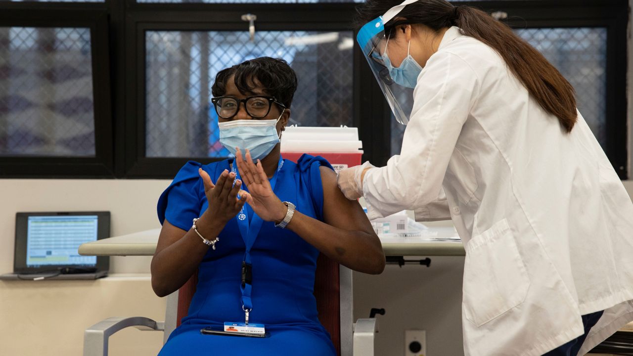 Nursing home staffer receives a dose of aCOVID-19 vaccine at the Harlem Center for Nursing and Rehabilitation in New York.