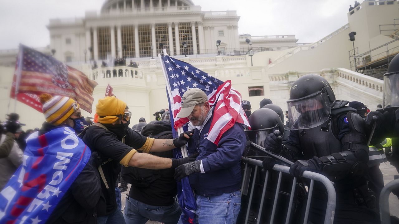 FILE - In this Jan. 6, 2021, file photo rioters try to break through a police barrier at the Capitol in Washington. (AP Photo/John Minchillo, File)