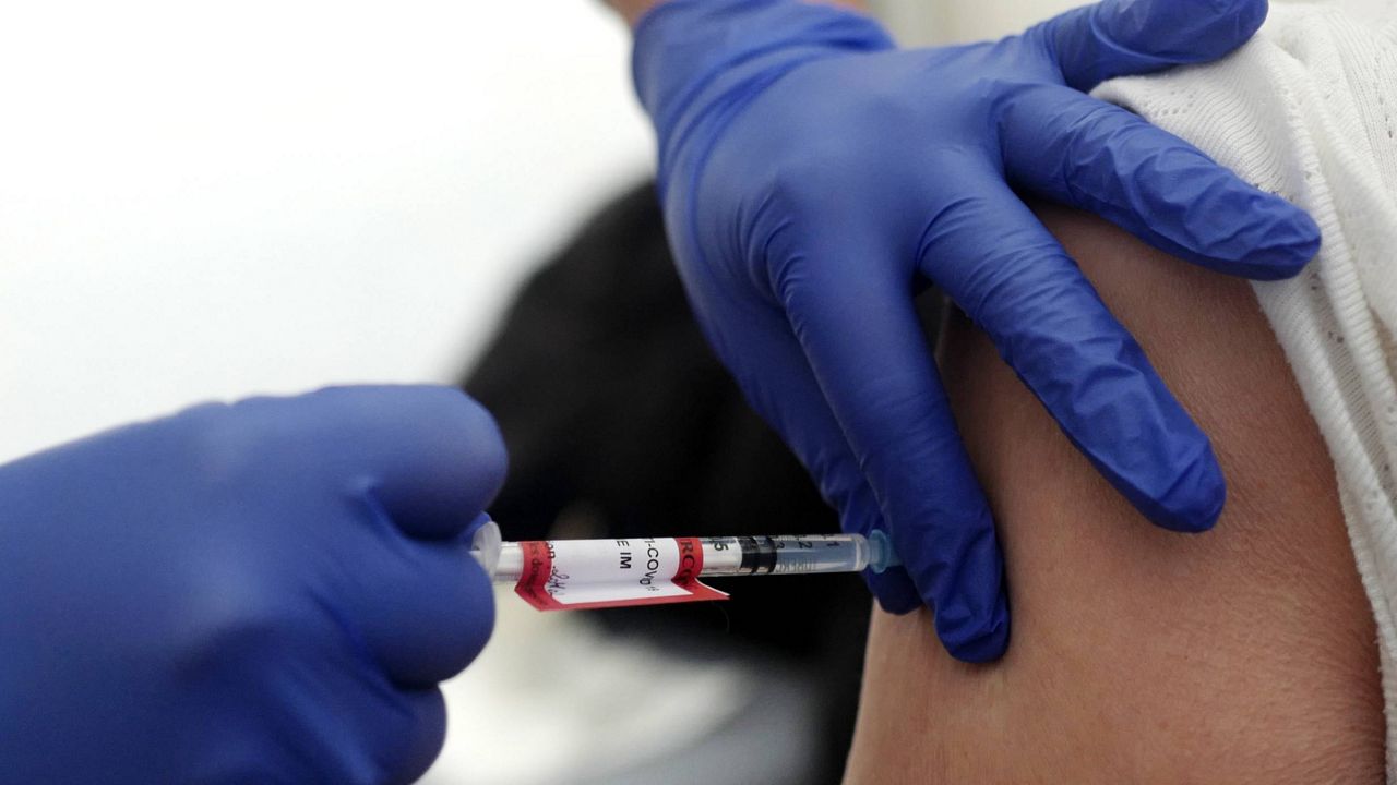 A woman receives the Pfizer-BioNTech vaccination. (AP Photo/Michel Spingler, File)