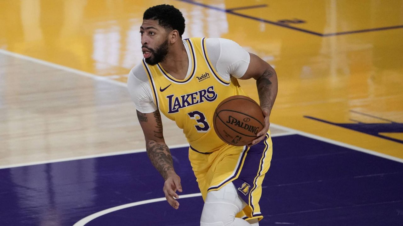 Lakers' Anthony Davis dribbles the ball during an NBA game against the Golden State Warriors, Monday, Jan. 18, 2021, in Los Angeles. (AP Photo/Jae C. Hong)