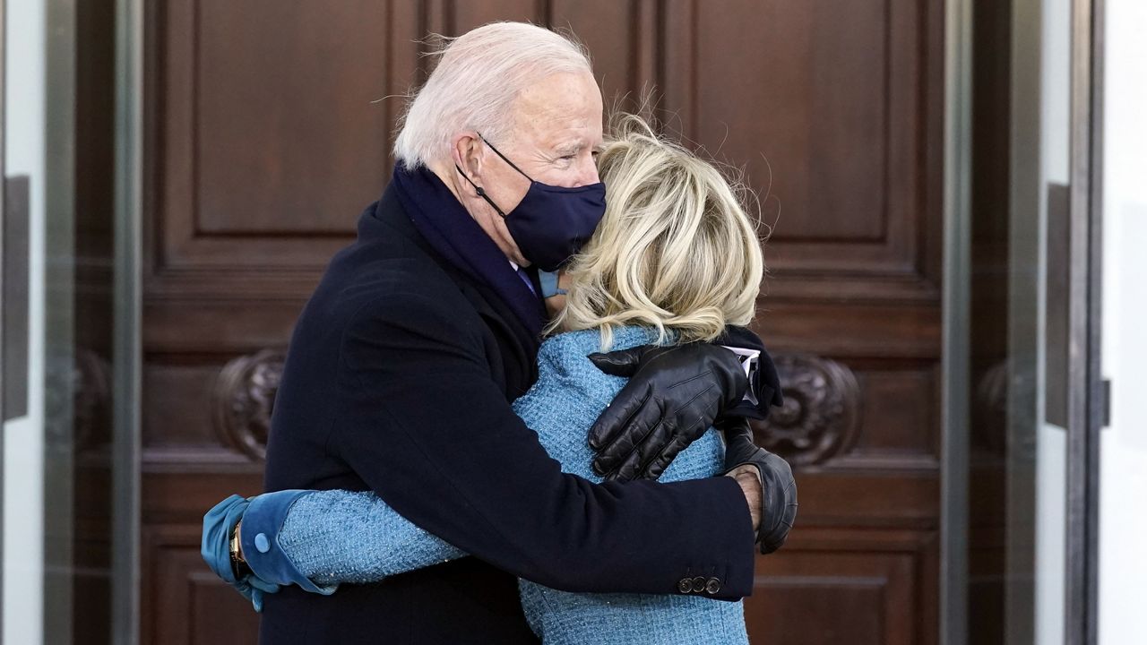 President Joe Biden and first lady Jill Biden hug as they arrive at the North Portico of the White House, Wednesday, Jan. 20, 2021, in Washington. (AP Photo/Alex Brandon, Pool)