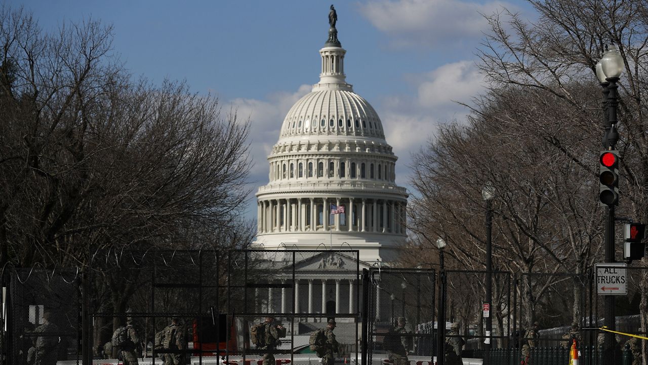 National Guard troops walk outside the Capitol. (AP Photo/Rebecca Blackwell)