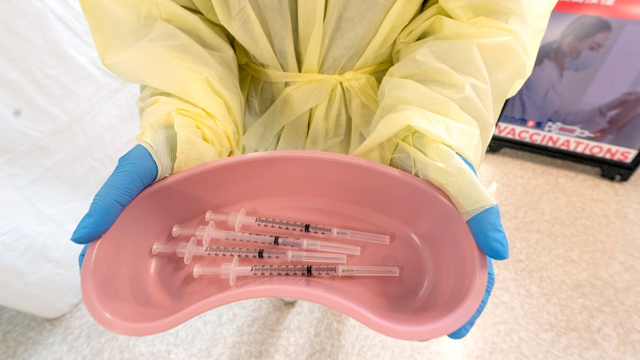 FILE - Health care professional prepares to distribute the COVID-19 vaccine. (Associated Press)
