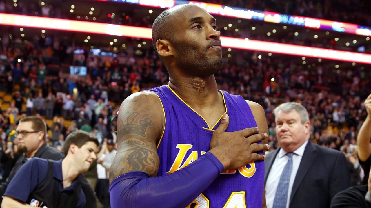 In this Dec. 30, 2015 file photo, Kobe Bryant touches his chest as he walks off the court in Boston after the Lakers' 112-104 win over the Boston Celtics in an NBA game. (AP Photo/Winslow Townson)