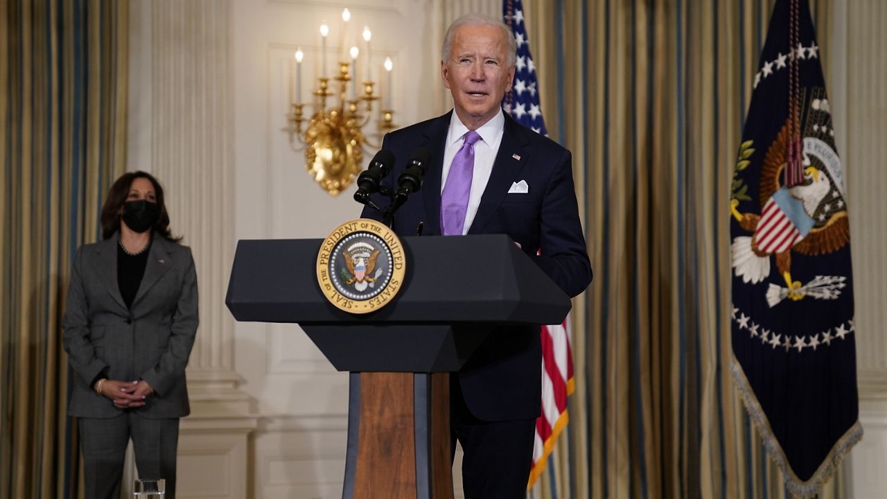 President Joe Biden delivers remarks on racial equity, in the State Dining Room of the White House, Tuesday, Jan. 26, 2021, in Washington. Vice President Kamala Harris listens at left. (AP Photo/Evan Vucci)