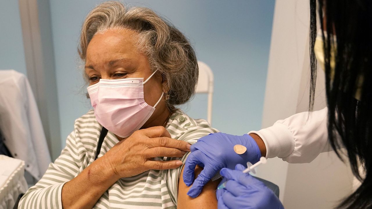 Irma Mesa, 74, receives the Pfizer-BioNTech COVID-19 vaccine on Jan. 27 at the Jackson Hospital in Miami. (AP Photo/Lynne Sladky, File)