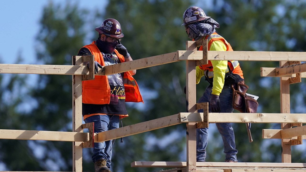 Construction workers talk at a USA Properties Fund site on Tuesday in Simi Valley, Calif. (AP Photo/Mark J. Terrill)