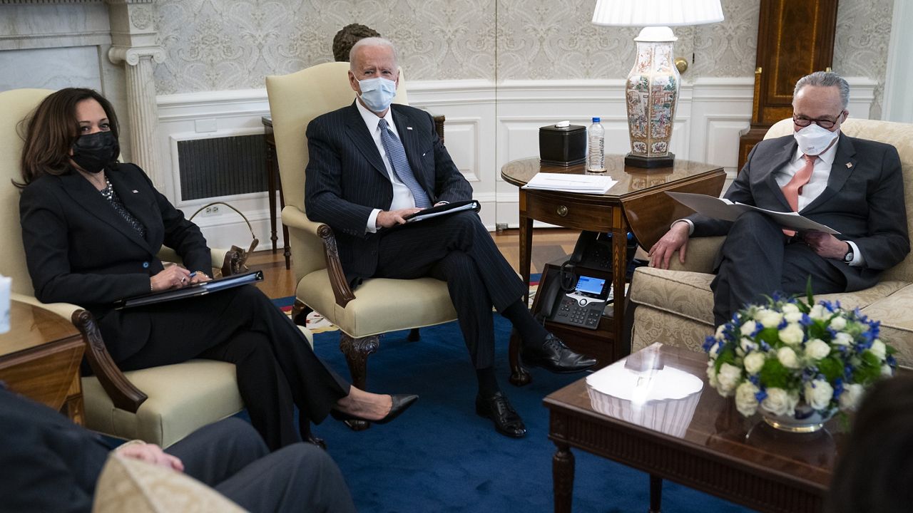 Vice President Kamala Harris, President Joe Biden, and Senate Majority Leader Sen. Chuck Schumer of N.Y., meet to discuss a coronavirus relief package, in the Oval Office of the White House, Wednesday, Feb. 3, 2021, in Washington. (AP Photo/Evan Vucci)