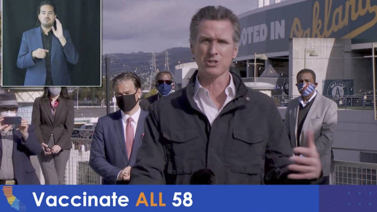 In this photo taken from video, is California Gov. Gavin Newsom speaking during a virtual briefing from the Oakland-Alameda County Coliseum in Oakland, Calif., on Feb. 3, 2021. (Office of the Governor via AP)
