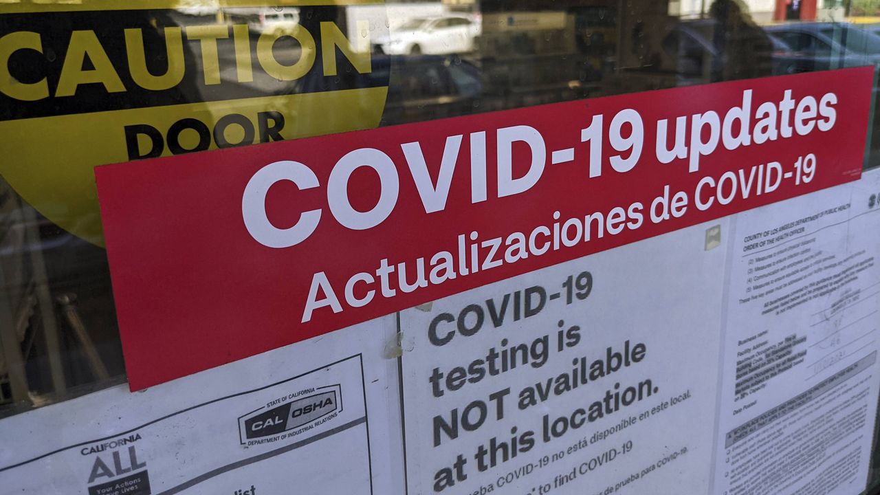 A sign is posted "COVID-19 testing in NOT available at this location," on the doors of a CVS pharmacy in Los Angeles Wednesday, Feb. 3, 2021. (AP Photo/Damian Dovarganes)