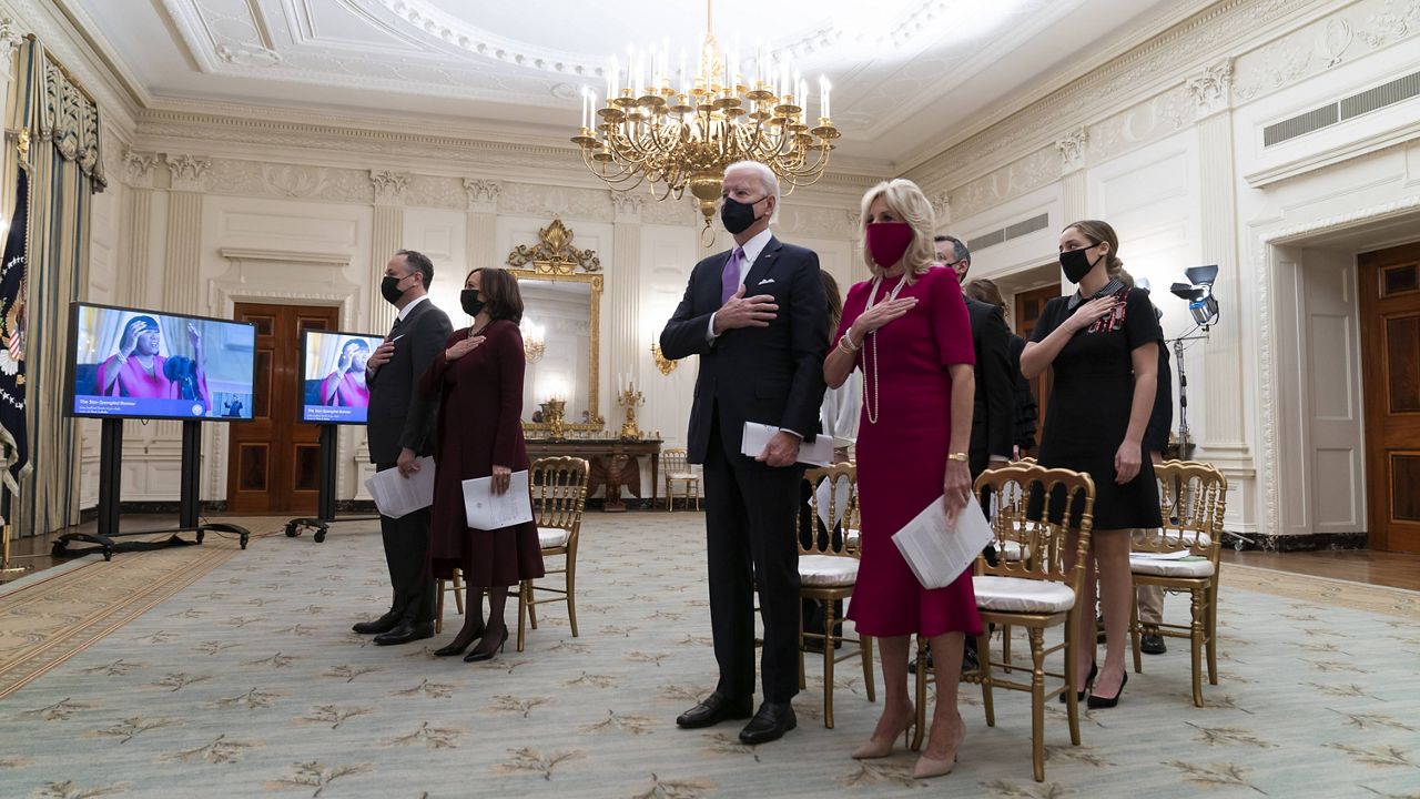 President Joe Biden, first lady Jill Biden and others stand for the national anthem during a virtual Presidential Inaugural Prayer Service in the State Dinning Room of the White House on Jan. 21. (AP Photo/Alex Brandon)