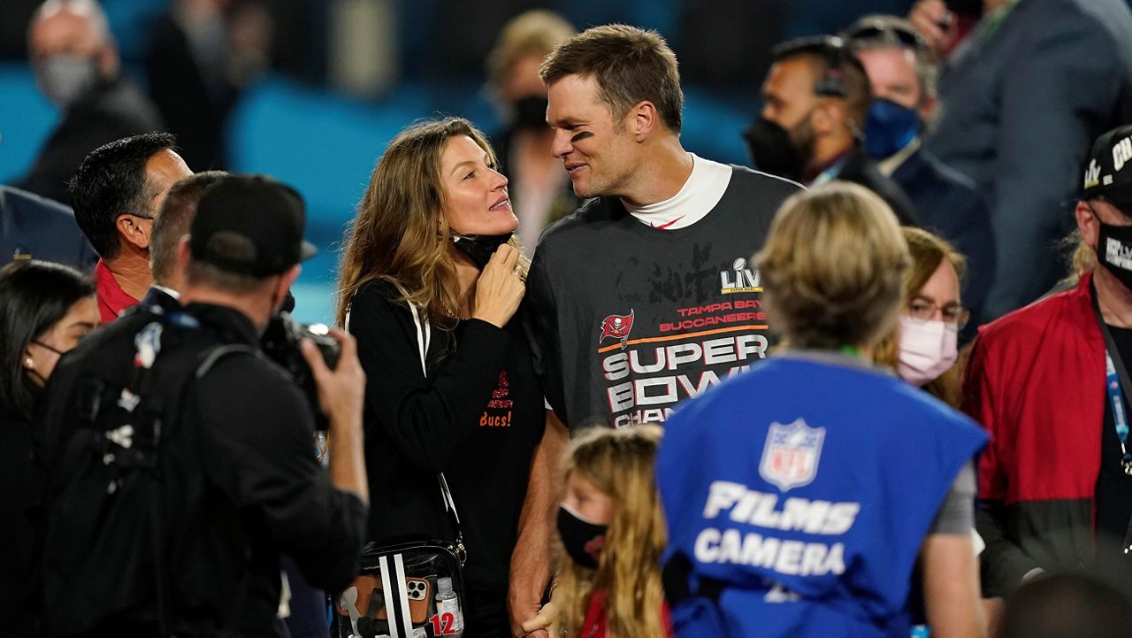 Tampa Bay Buccaneers quarterback Tom Brady walks with Gisele Bundchen on the field after the NFL Super Bowl 55 football game against the Kansas City Chiefs, Sunday, Feb. 7, 2021, in Tampa, Fla. (AP Photo/Steve Luciano)
