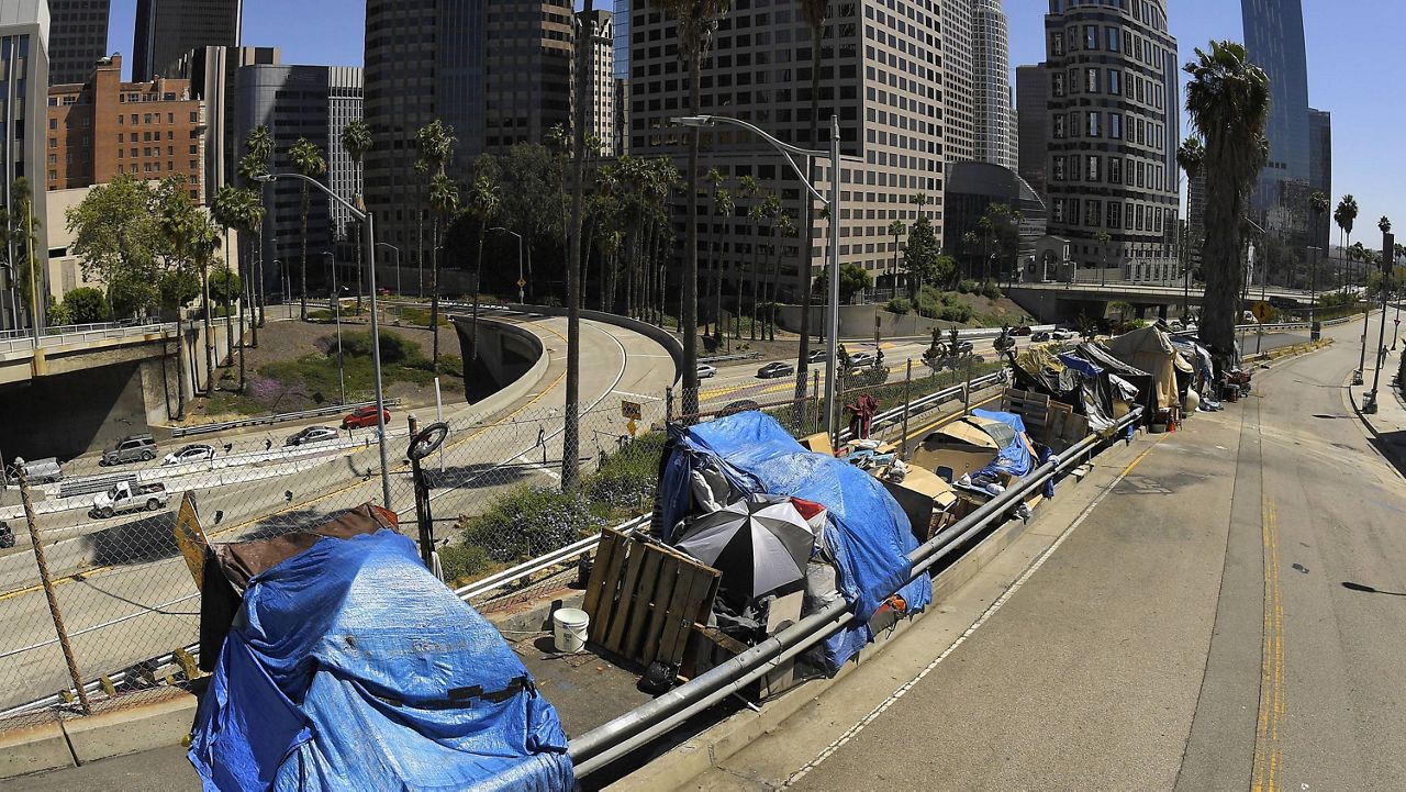 A homeless encampment on Beaudry Avenue is seen as traffic moves along Interstate 110 in downtown Los Angeles on May 21, 2020. (AP Photo/Mark J. Terrill)