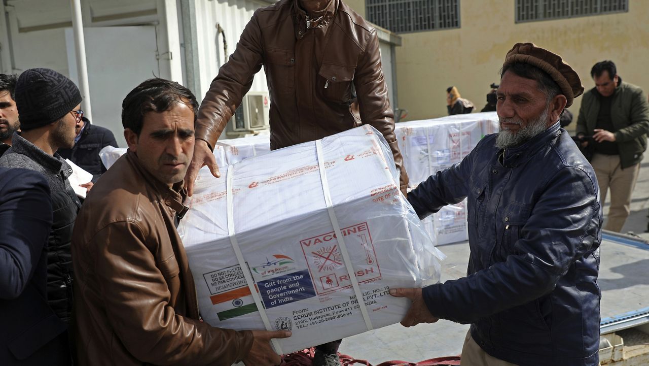 FILE - In this file photo dated Sunday, Feb. 7, 2021, Afghan health ministry workers unload boxes of the first shipment of 500,000 doses of the AstraZeneca coronavirus vaccine made by Serum Institute of India, donated by the Indian government to Afghanistan, at the customs area of the Hamid Karzai International Airport, in Kabul, Afghanistan. (AP Photo/Rahmat Gul, FILE)