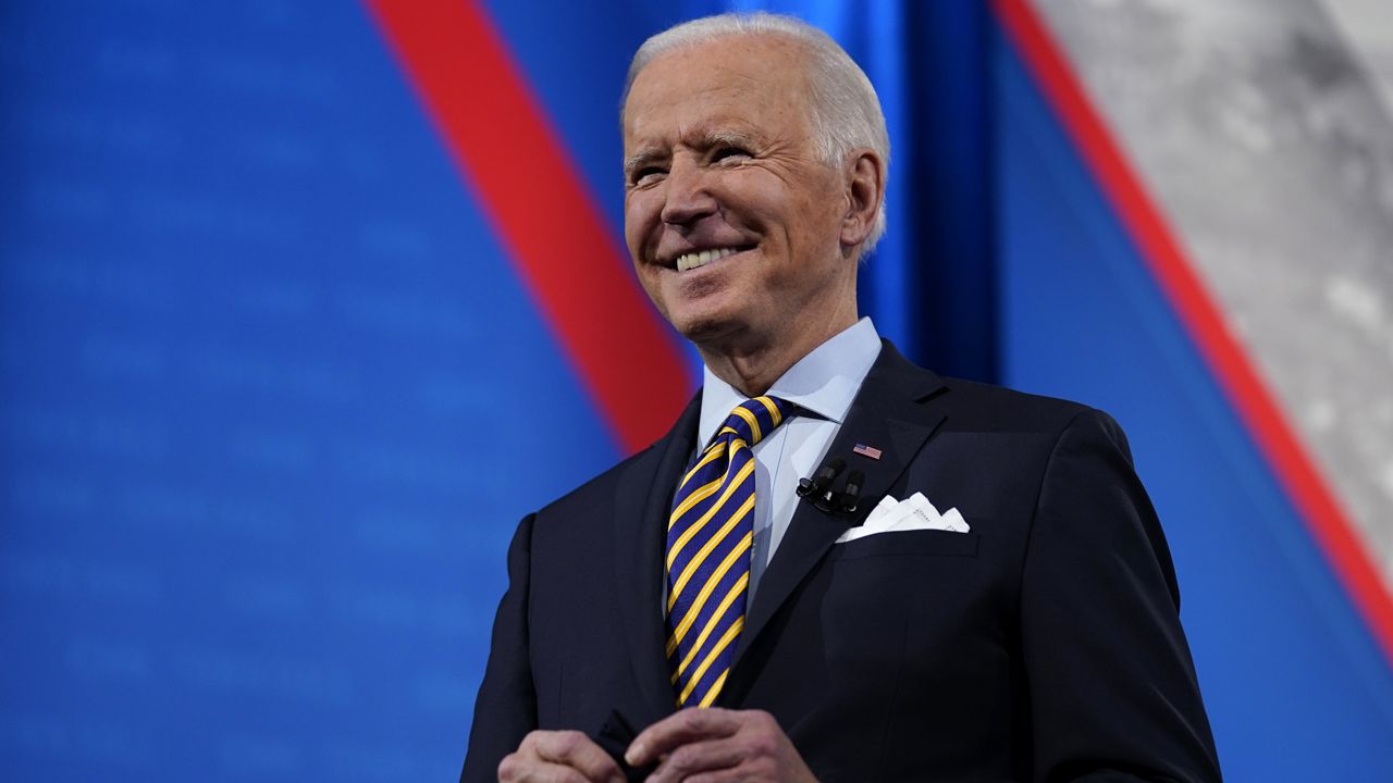 President Joe Biden stands on stage during a break in a televised town hall event at Pabst Theater, Tuesday, Feb. 16, 2021, in Milwaukee. (AP Photo/Evan Vucci)