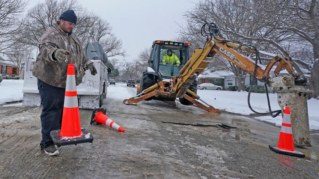 City of Richardson workers prepare to work on a water main pipe that burst due to extreme cold in a neighborhood Wednesday, Feb. 17, 2021, in Richardson, Texas. (Associated Press)