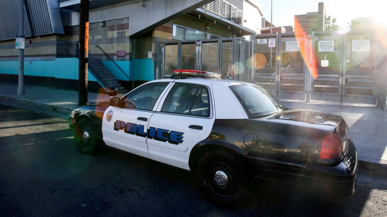 In this Dec. 15, 2015, file photo, a police car is parked outside of Miguel Contreras Learning Complex in Los Angeles. (AP Photo/Ringo H.W. Chiu)